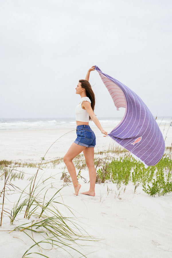 Blue beach towel with red fish swimming upstream